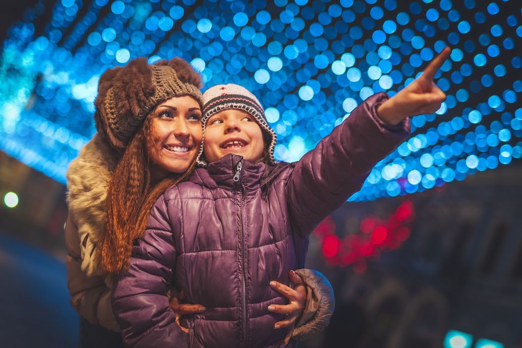 Mother and daughter enjoying holiday lights display in Nashville during the festive season.