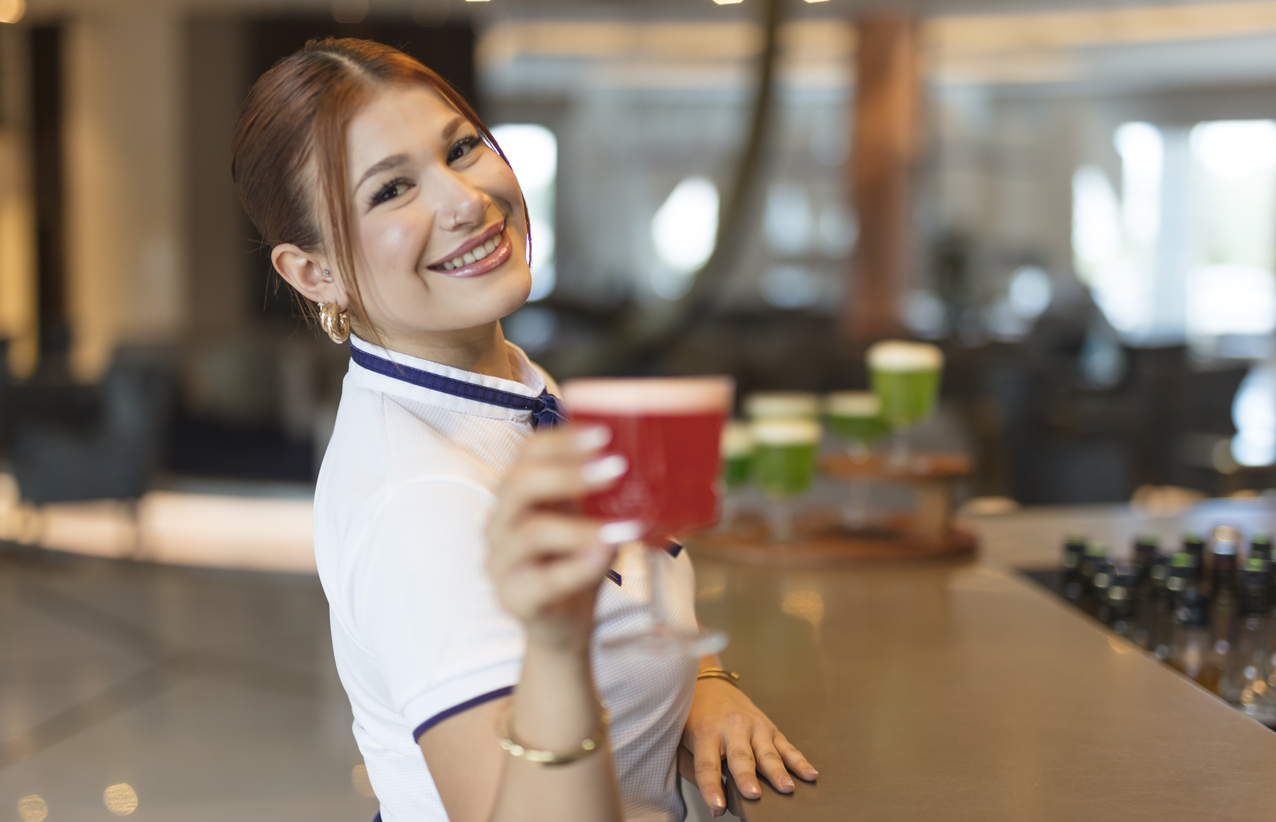 Flight crew member relaxing with drink at hotel bar near Nashville Airport